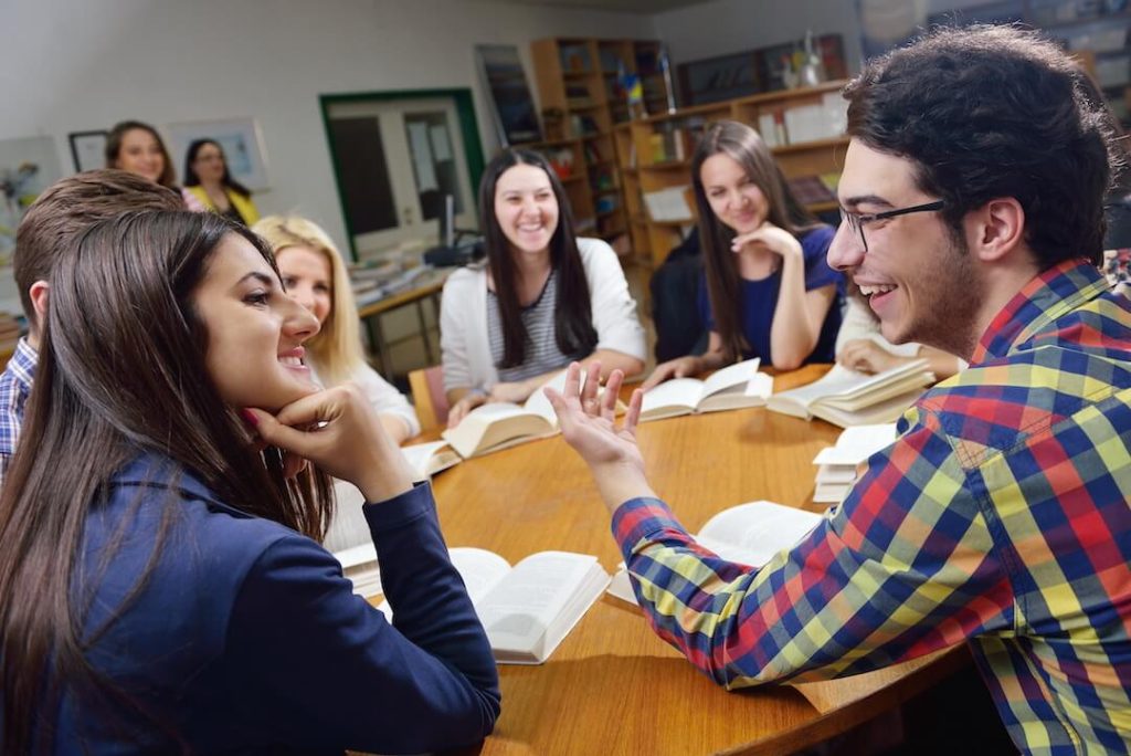 students discussing a book