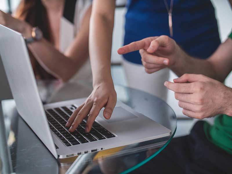 laptop and hands of people